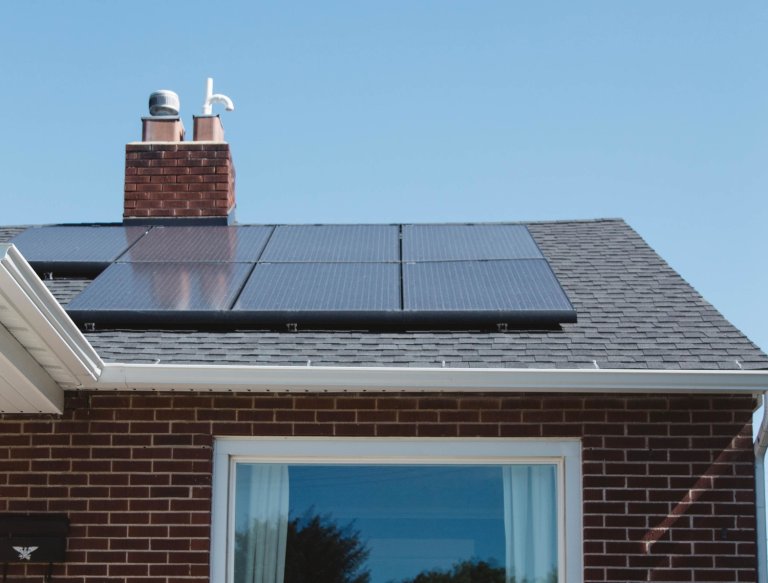 a residential home with solar panels on the roof