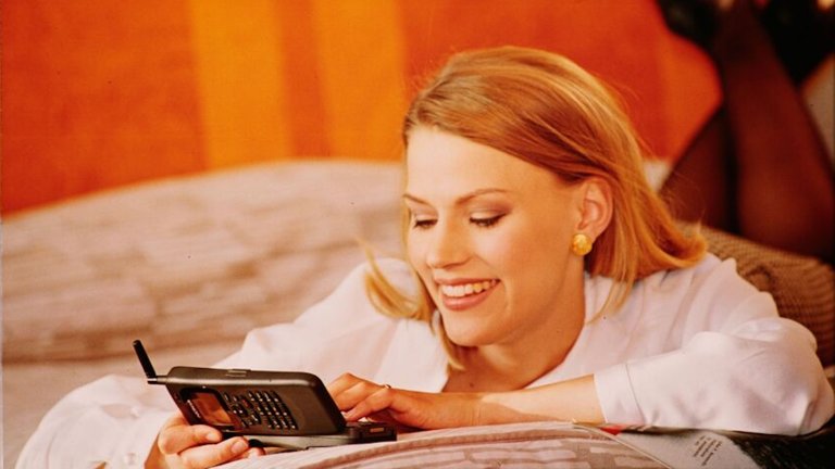 Woman using old cell phone in Nokia ad