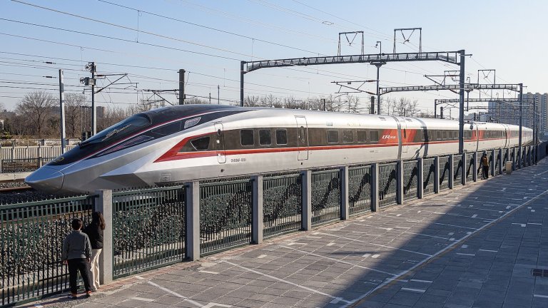 CR450AF high speed train on track in China with two people looking at it
